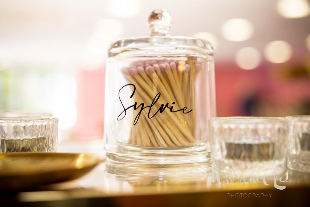Glass bottle matches labelled 'Sylvie' with matches on a blurred background