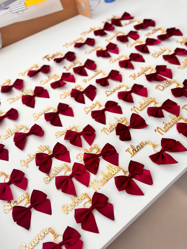 Acrylic Place Names red bows with gold acrylic name tags