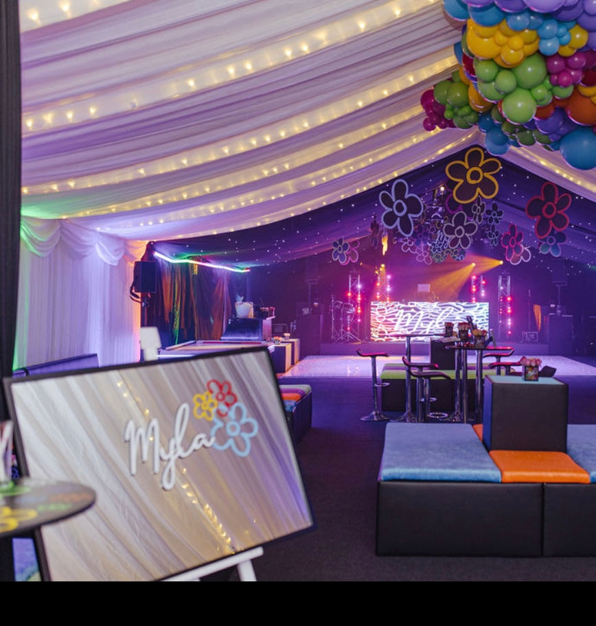 Decorated event space with colourful balloons and a 'Mylar' bespoke mirror