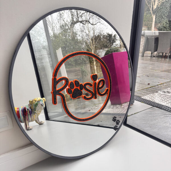 Round bespoke mirror with 'Rosie' and paw print design, dog visible in reflection