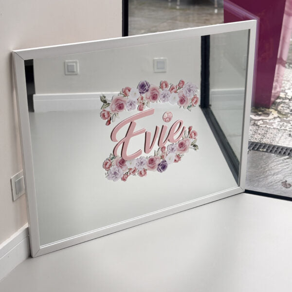 Decorative bespoke mirror with floral design and 'Evie' text in a room setting.