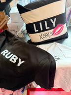Black hoodie with 'RUBY' text and a logo pillow with 'LILY' and 'XOXO' text