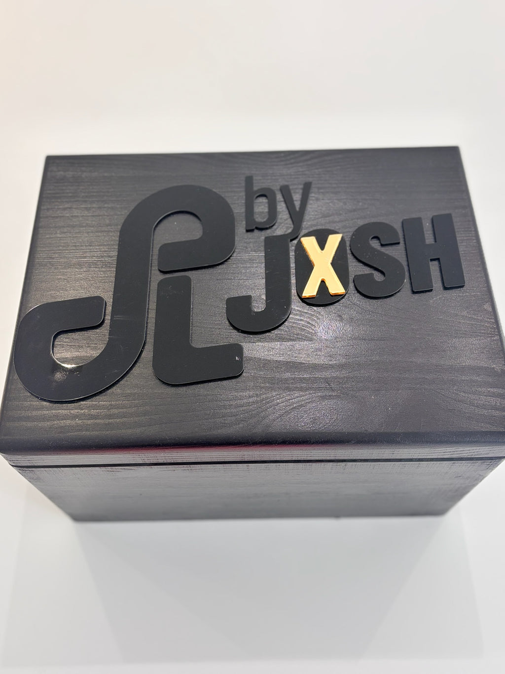 Black keepsake box with 'by JXSH' branding on a white background
