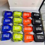 Multiple small boot bags with names printed on them arranged in a grid.