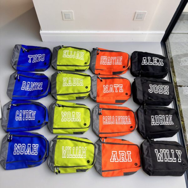 Multiple small boot bags with names printed on them arranged in a grid.