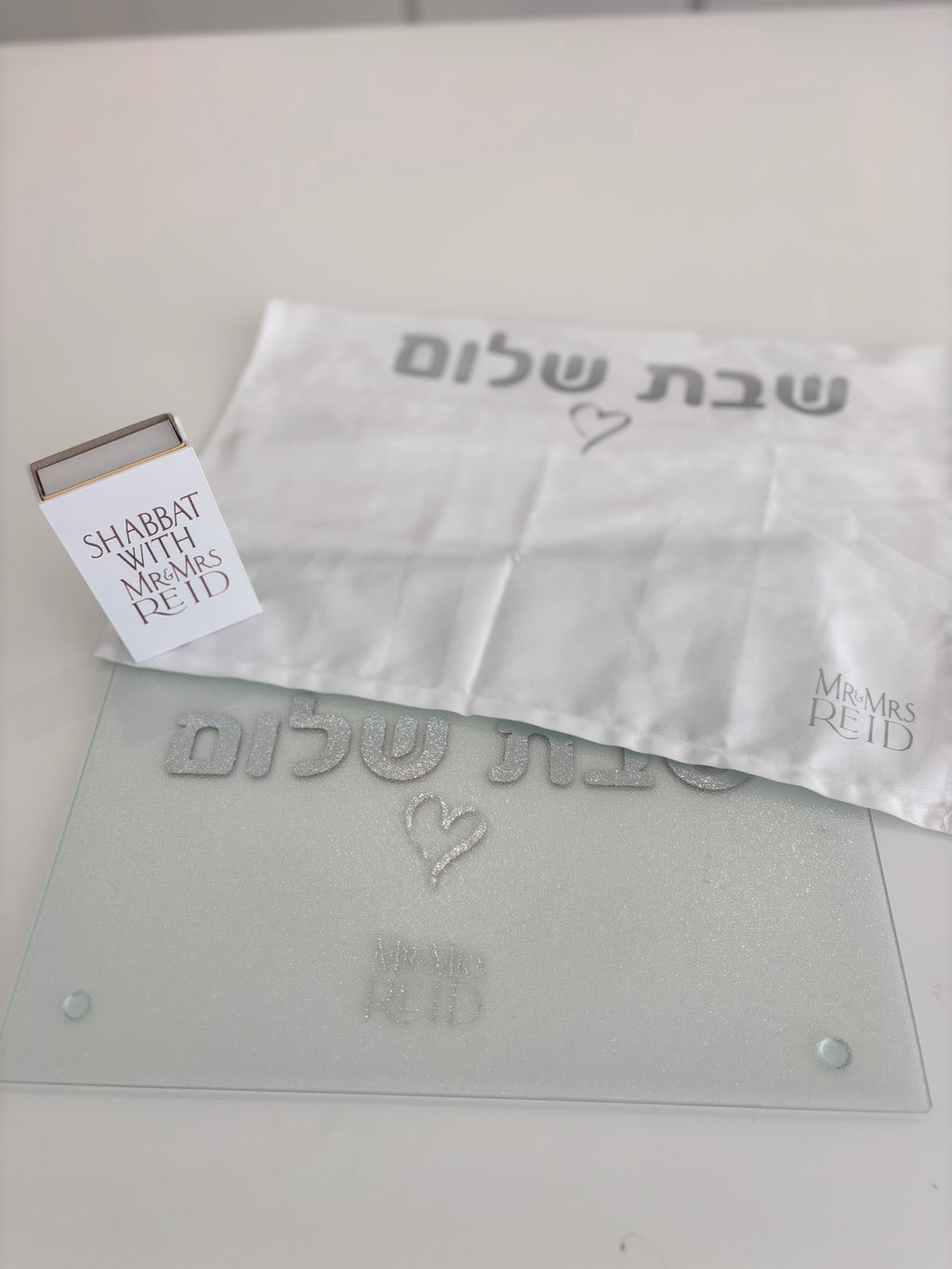 Challah cover with a matching challah board, cover and match box that says Shabbat with Mr and Mrs Reid