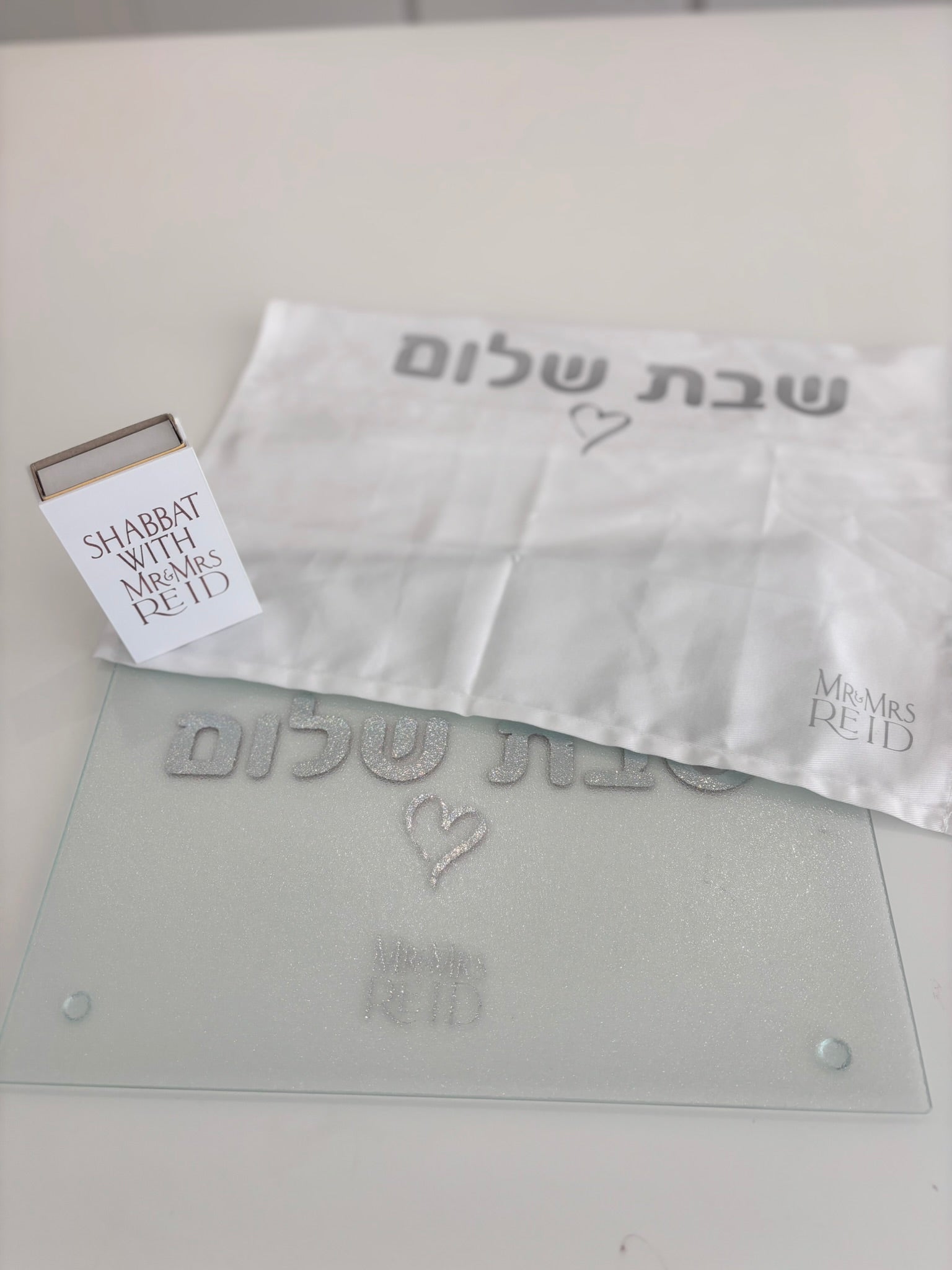 Challah cover with a matching challah board, cover and match box that says Shabbat with Mr and Mrs Reid