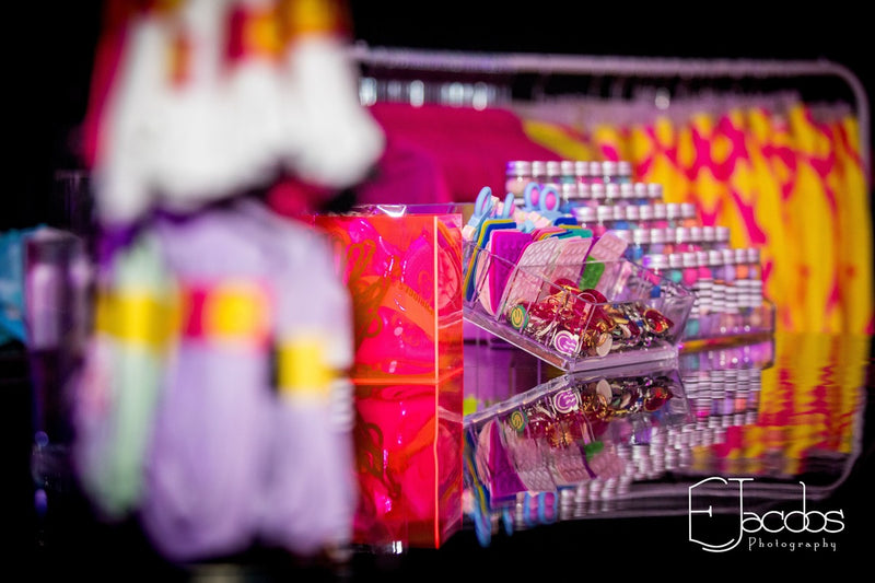 Colourful merch stand with fidget toys and coins,  blurred background from Mirrored Memories