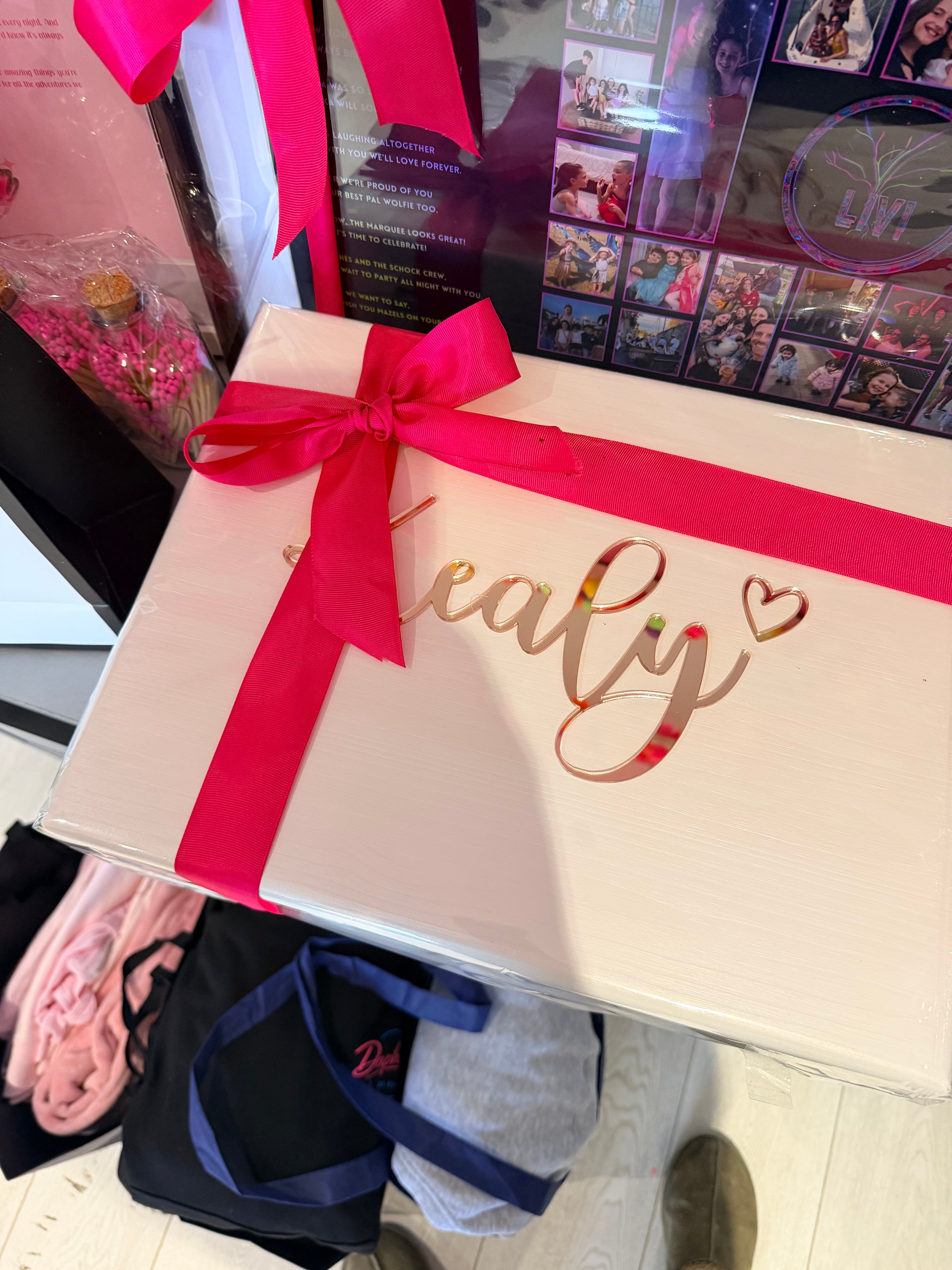 Cream keepsake box with a red ribbon on a cluttered surface