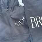 Dark grey hoodie with 'Brooke' branding on a matching sweatshirt.