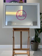 Decorative classic mirror on an easel with a white frame and 'Olivia' on pink acrylic.
