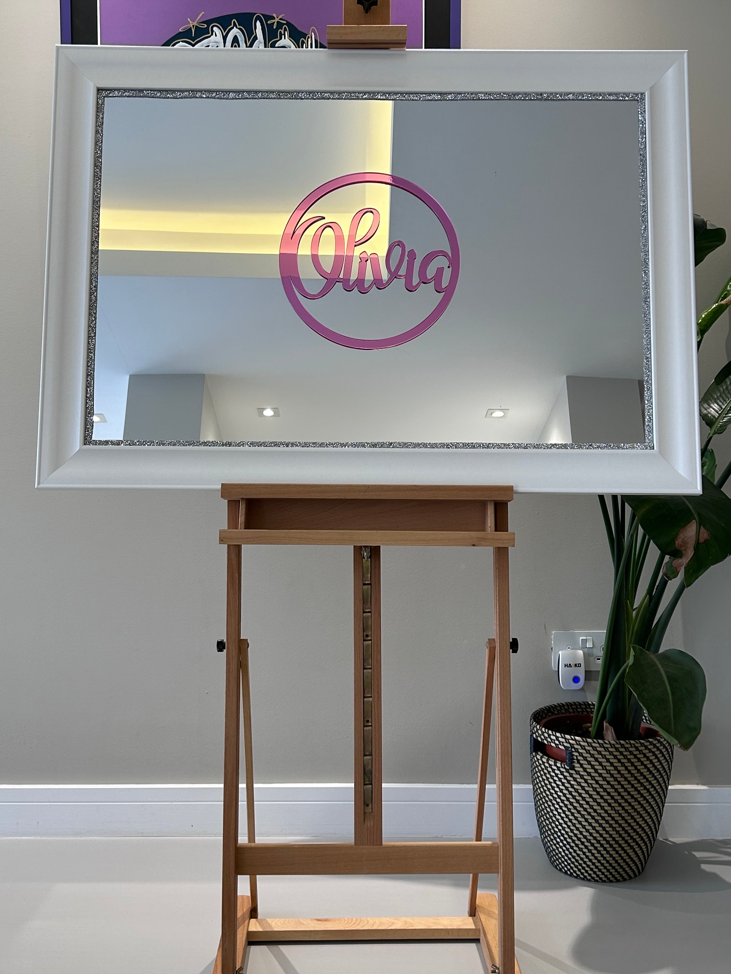Decorative classic mirror on an easel with a white frame and 'Olivia' on pink acrylic.