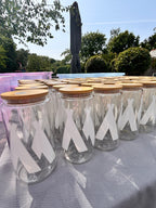 Decorative cold cups with white labels on a stand outdoors