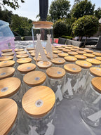 Decorative cold cups with white labels on a stand outdoors and wooden lids