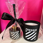 FREDDIE diffuser bottle and candle set with black ribbon against a pink background
