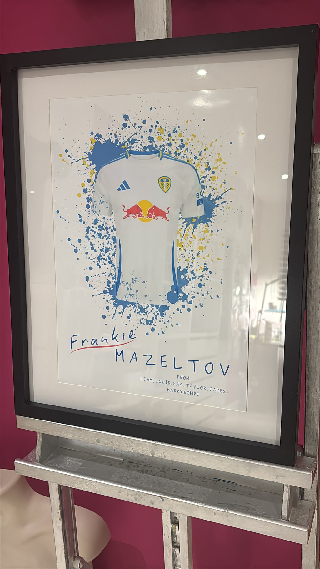 Framed football gift, blue and white football shirt with a black frame, on a white background.