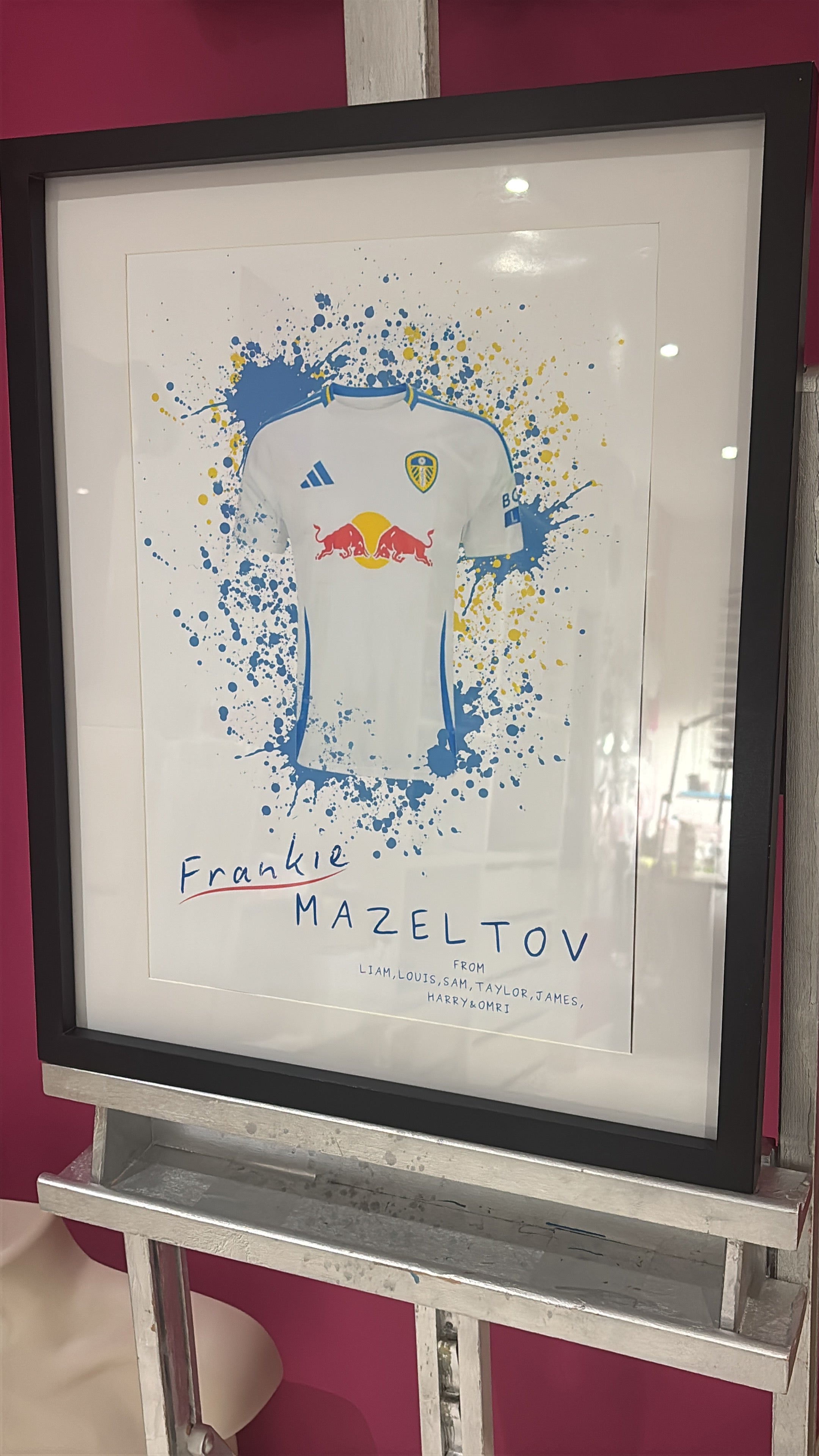 Framed football gift, blue and white football shirt with a black frame, on a white background.