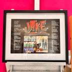 Framed speech gift with 'JAKE' design on a pink wall with no acrylic