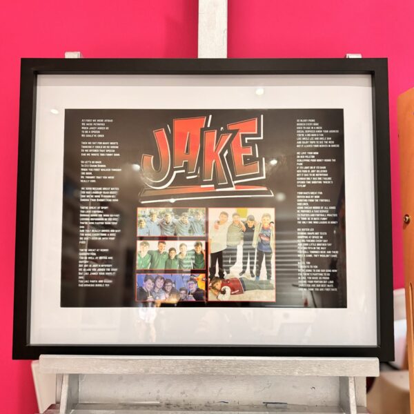 Framed speech gift with 'JAKE' design on a pink wall with no acrylic