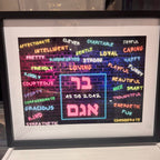 Framed speech gift with colourful text and Hebrew letters on a white surface with no acrylic.