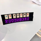 Personalised board game component with numbers and a brand name on a white surface