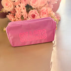 Raspberry ripple washbag with 'SNACKS' text in front of pink roses