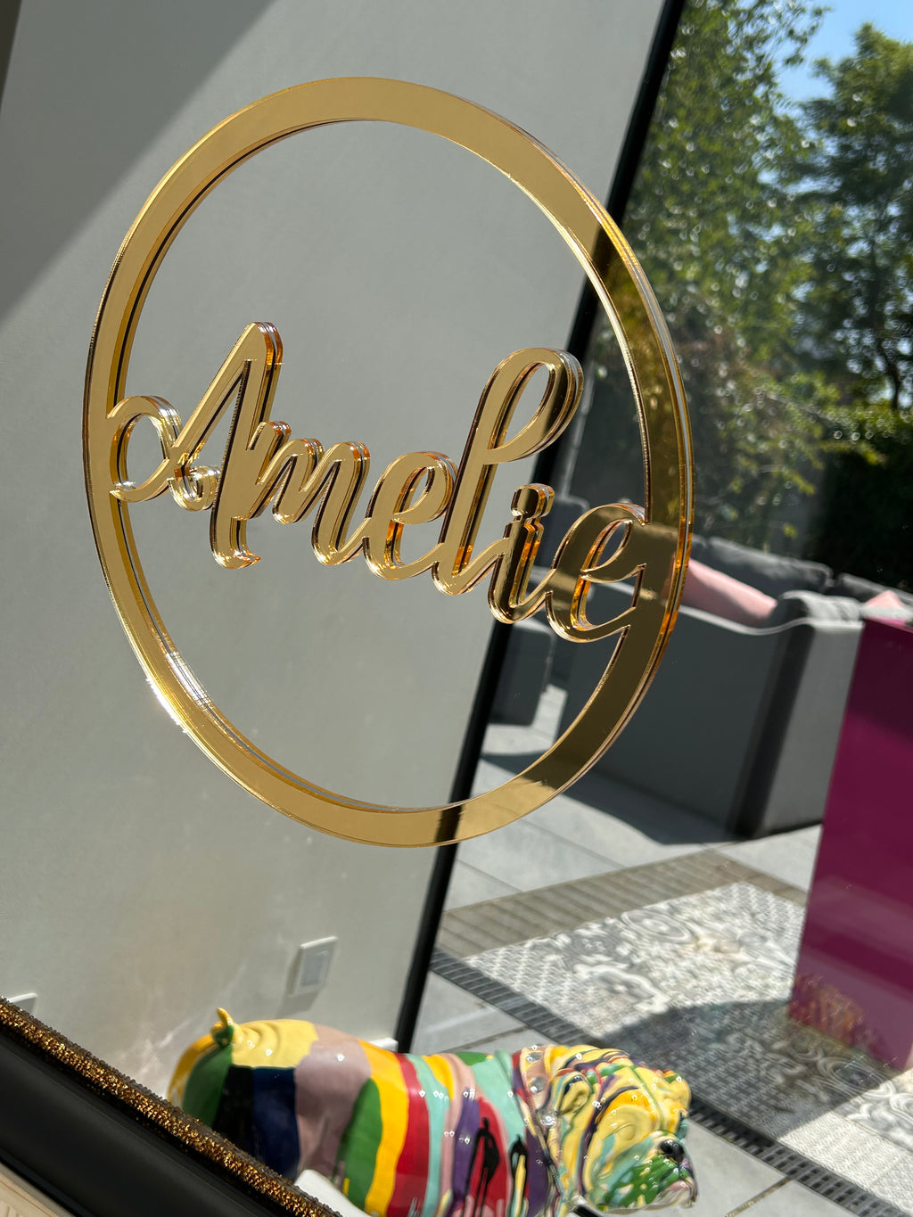 Gold acrylic name spelling 'Amelia' on a classic mirror.