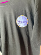 Grey event t-shirt with a Liberty label on a pink background