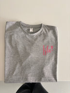 Grey event t-shirt with a red logo
