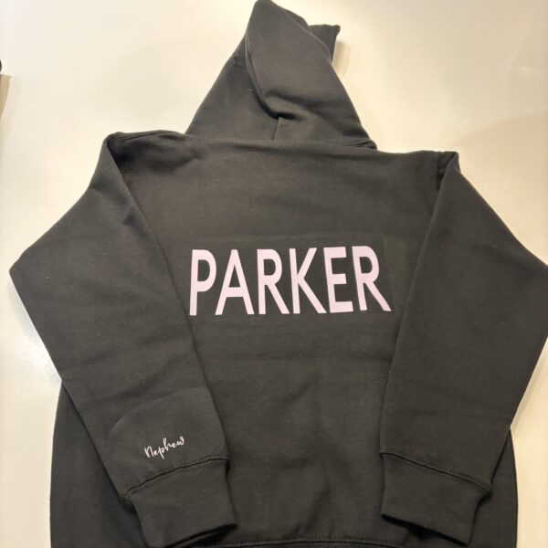 Dark grey hoodie with 'PARKER' printed on the back, laid flat on a light surface.