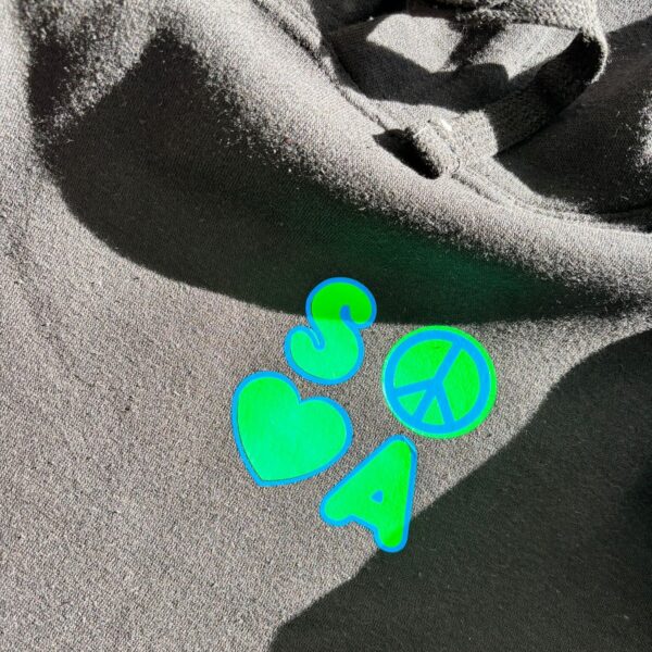 Neon green 'SOSA' logo on black hoodie