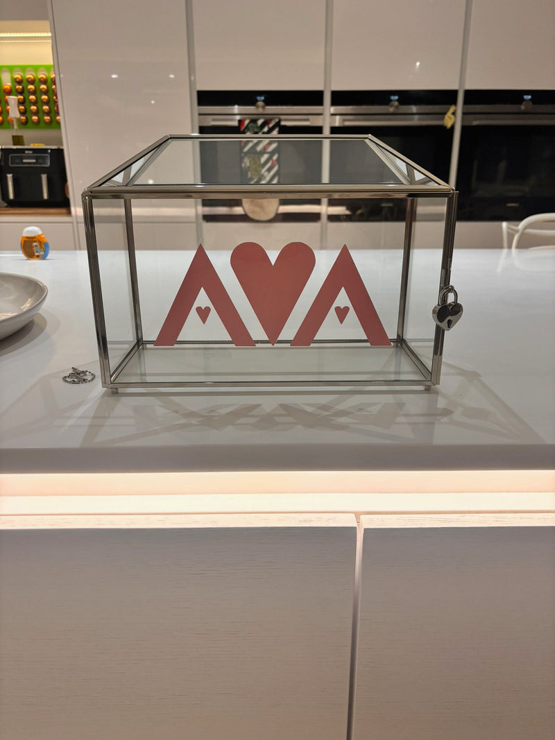 Clear gift card box with 'AVA' logo on a kitchen counter