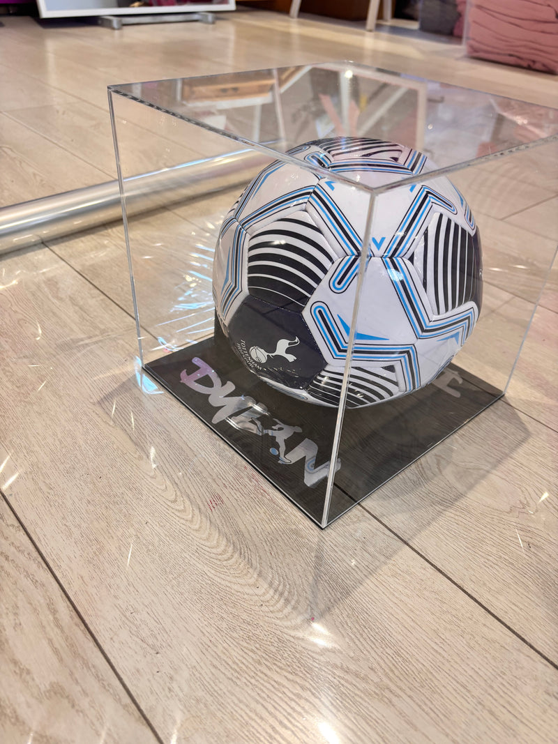 Personalised Tottenham Hotspur football on a glass table with a brand name on the table