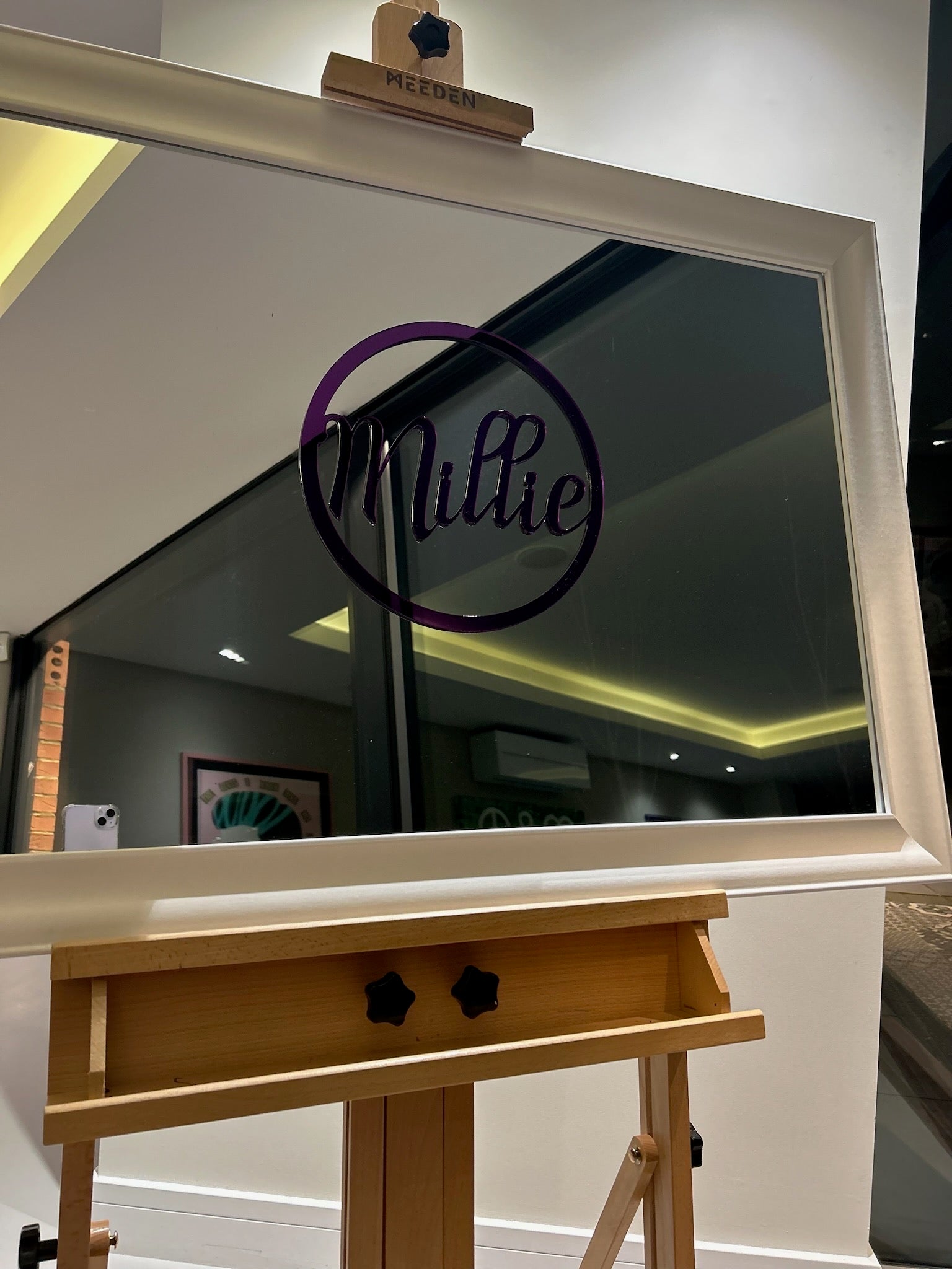 Large classic mirror on a wooden stand with 'Millie' logo in the reflection