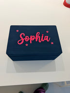 Navy blue keepsake box with pink text 'Sophia' on a white surface