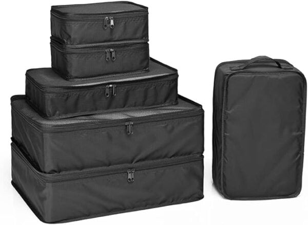 Set of black packing cubes in various sizes on a white background