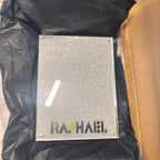 Clear acrylic photo frame with 'RA.PHAEL' branding on a black background