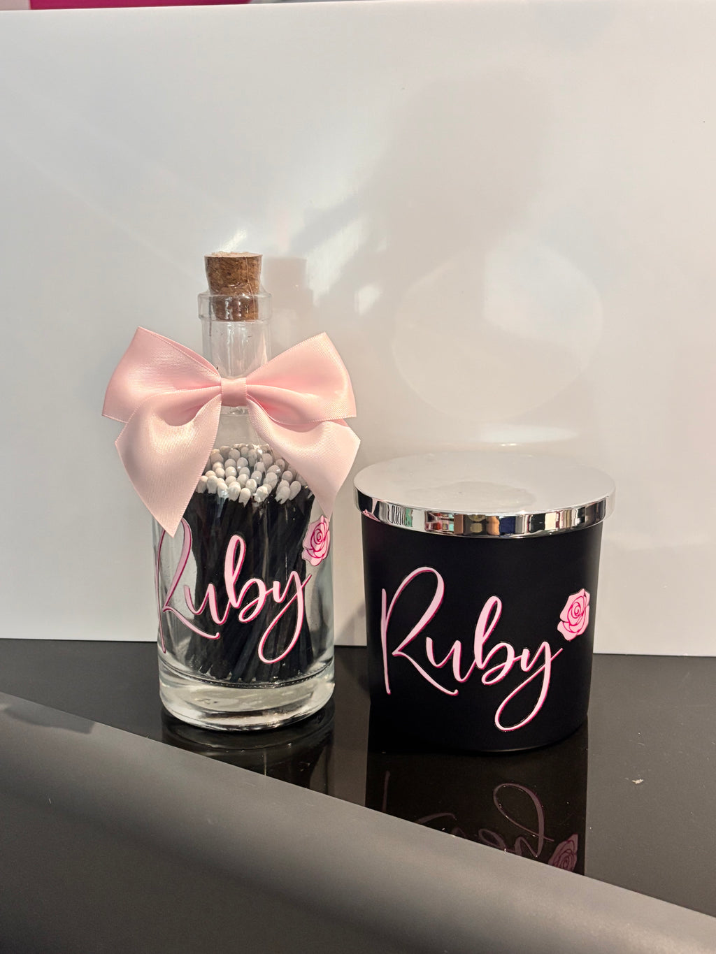 Pink and black diffuser and match bottle set with "Ruby" personalised in pink lettering.