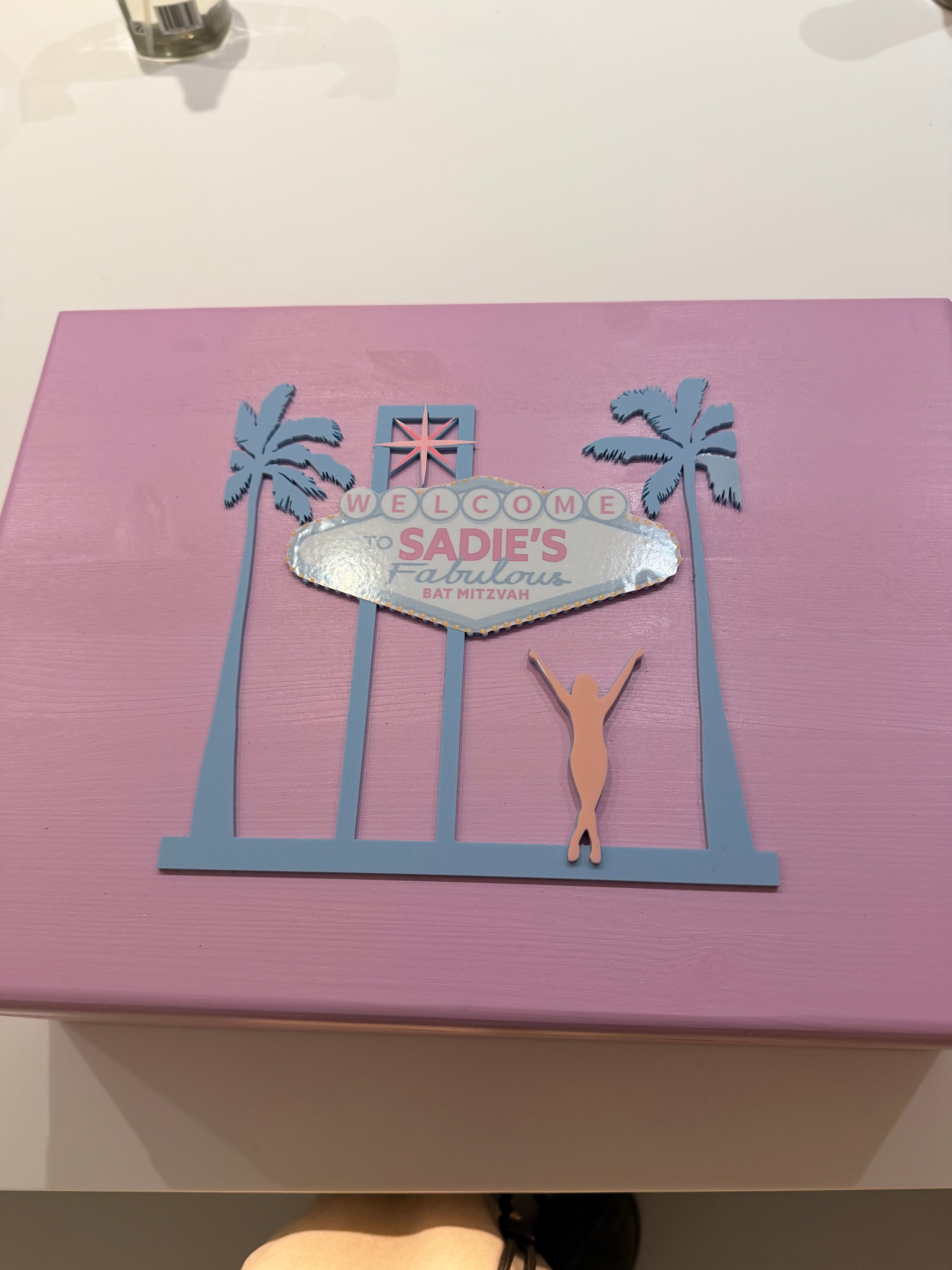 Pink keepsake box with cut-out designs and 'Welcome Sadie's' text on a white background