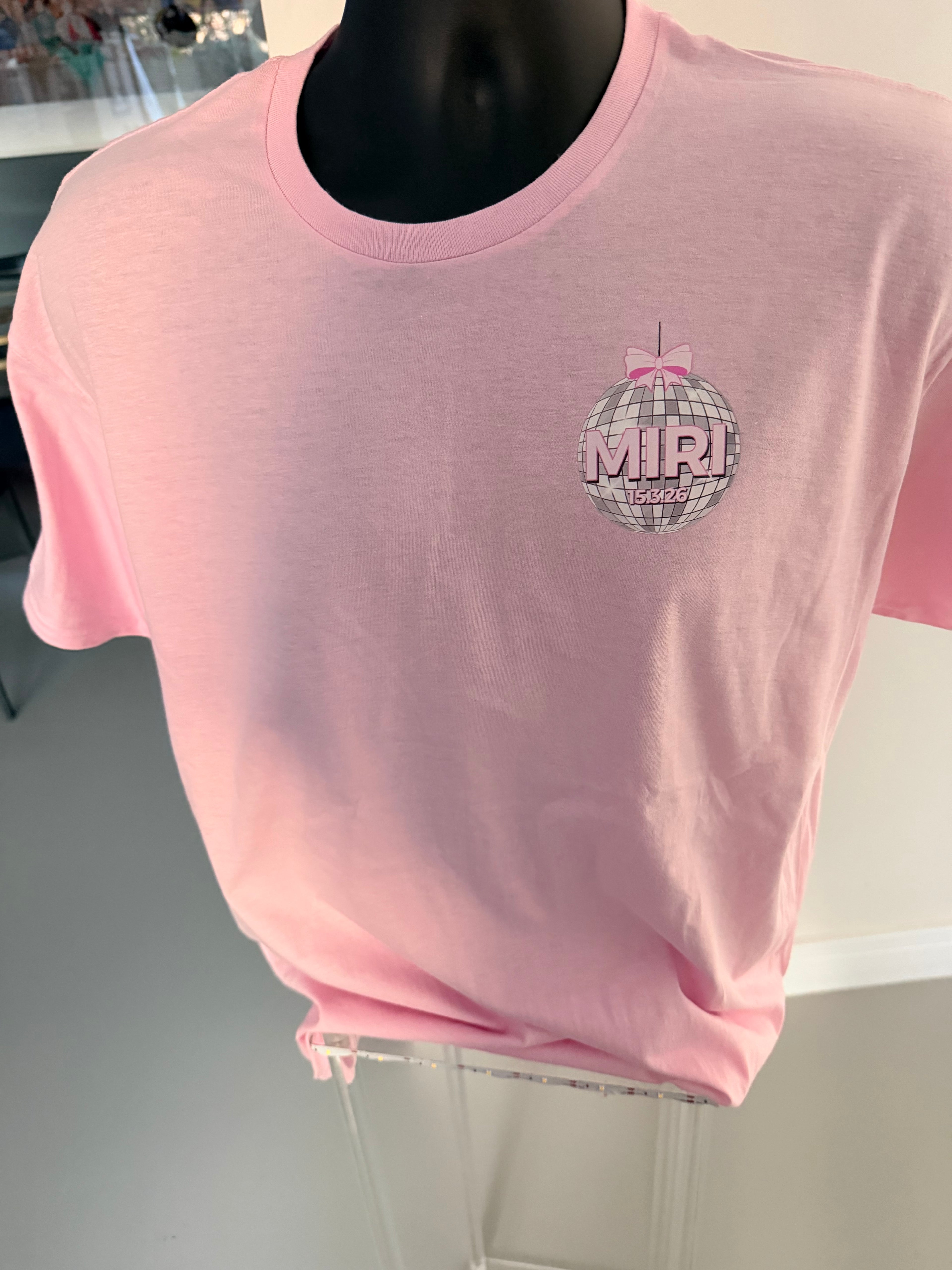Pink short sleeved event t-shirt with a graphic design on a mannequin against a neutral background