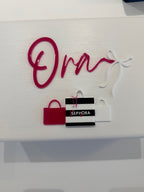 Red Sephora branded bag with 'Ora' personalised name on a white keepsake box
