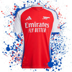 Red and white Arsenal football shirt with Emirates logo on a colourful splatter background