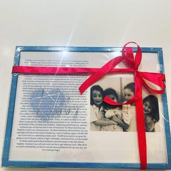 Framed speech gift with a photo of three children and a red ribbon on a white background with no acrylic.