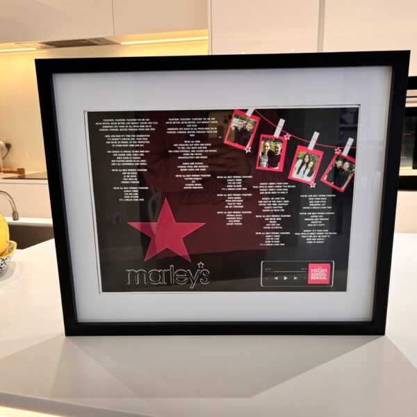 Framed speech gift with a red star and 'Marley's' branding on a kitchen counter with acrylic