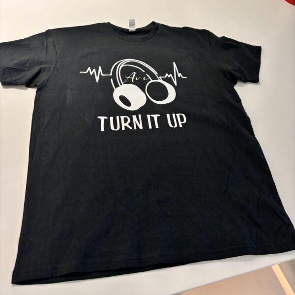 Black t-shirt with white graphic and text on a light grey background