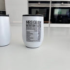 White travel cup with 'Mrs Gray Nutrition Facts' text on a kitchen counter.