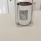 White travel cup with 'Teacher Nutrition Facts' text on a white surface.