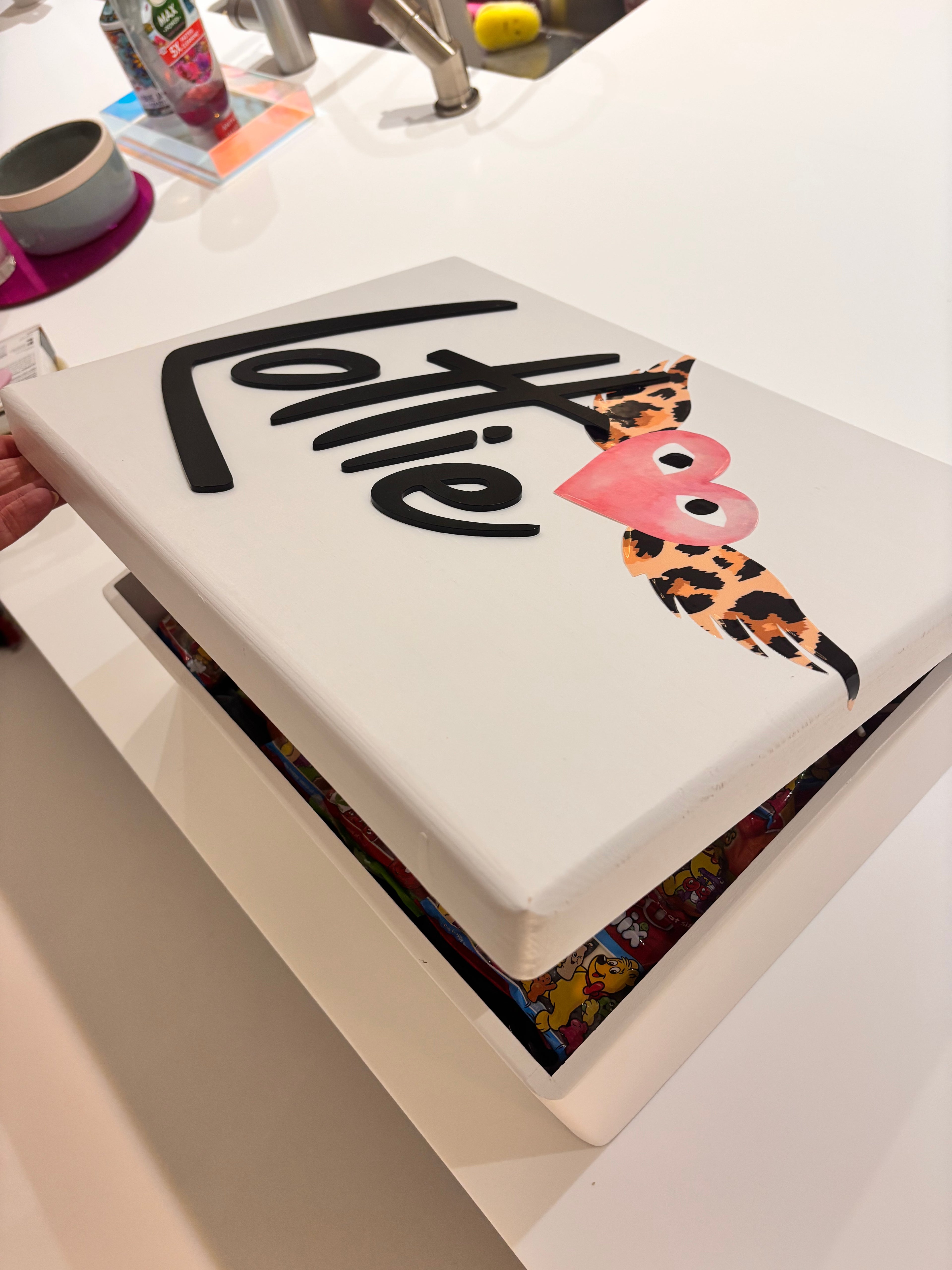 White keepsake box with 'Lottie' branding and decorative heart design on a white background