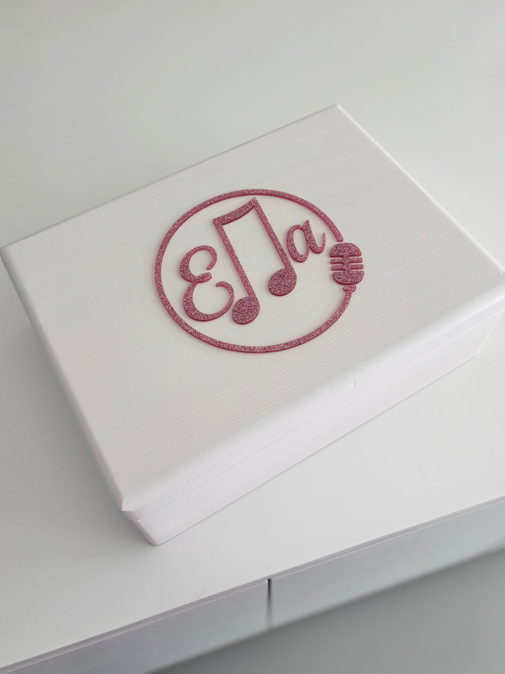 White keepsake box with a decorative acrylic name 'Ella' on a light grey background