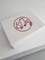 White keepsake box with a decorative acrylic name 'Ella' on a light grey background